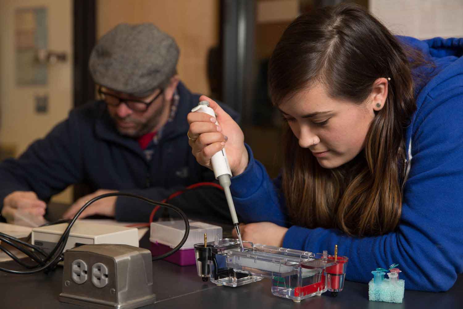 Two students examining chemical compounds.